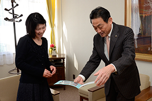 （写真）昨年の寄付で購入した本を見た東社長